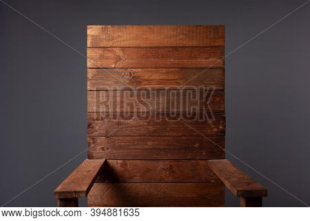 A Wooden Throne Chair On A Gray Background In A Photo Studio