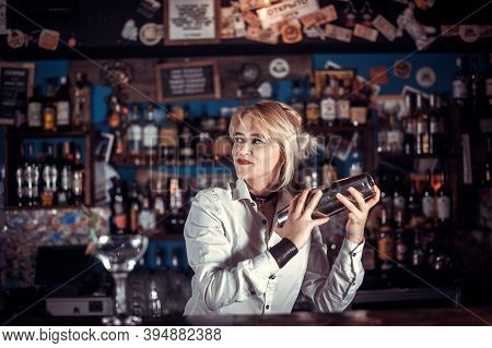 Girl Barman Concocts A Cocktail In The Saloon