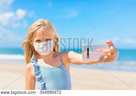 Funny Girl Taking Selfie Photo By Smartphone On Tropical Sea Beach. New Rules To Wear Cloth Face Cov