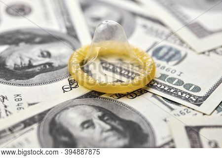 Condom On Dollars Bills. Prostitution Concept. Us Dollar Money On Table With Contraceptive. Pay For 