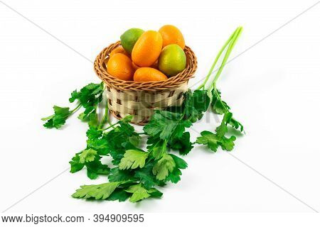 Citrus Fruits In A Basket Exotic Kumquats And Limequats On A White Isolated Background And With Gree