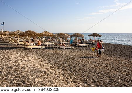 Santorini, Greece - September 16, 2020: Vlychada Beach Covered With Dark Grey Sand. Southern Side Of