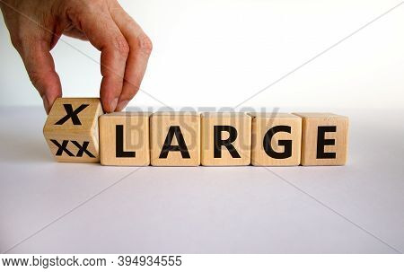 Reducing Weight Concept. Hand Turns A Cube And Changes The Words 'xx Large' To 'x Large'. Beautiful 