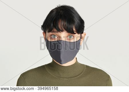Face mask mockup on a women in a green turtleneck top