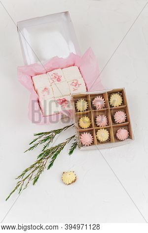 Composition Of Sweets Packed In Boxes Three In A Row. Top View.