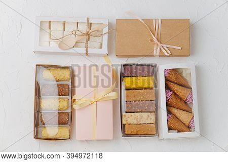 Variety Of Sweets In Windowed And Sealed Boxes. Top View. On White Surface.