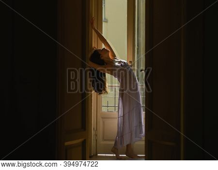 Women In Translucent Nightie. Young Woman Standing Near Balcony. Fashion Model In Sexy Nightie. Attr