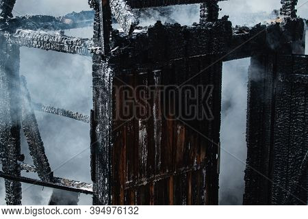 Aftermath Of Fire Disaster. Smoke After Great Fire. Burned Down To The Ground Wooden House