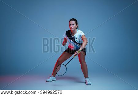 Beautiful Handicap Woman Practicing In Badminton Isolated On Blue Background In Neon Light. Lifestyl