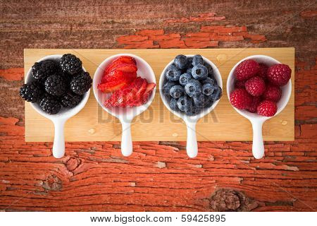 Fresh Assorted Berries On A Grungy Wooden Counter