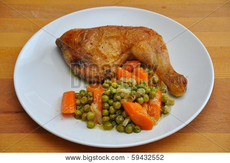 roast chicken leg with peas and carrots