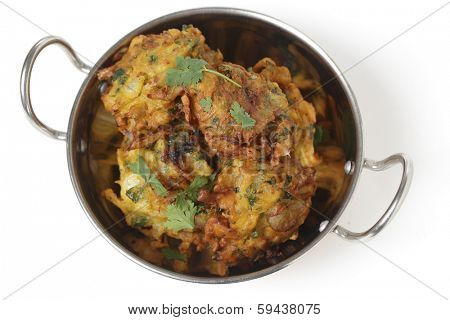 Homemade onion bhaji Indian appetisers in a kadai serving bowl, seen from above