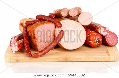 Lot of different sausages on wooden board isolated on white
