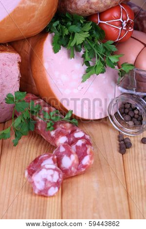 Lot of different sausages on wooden table close-up