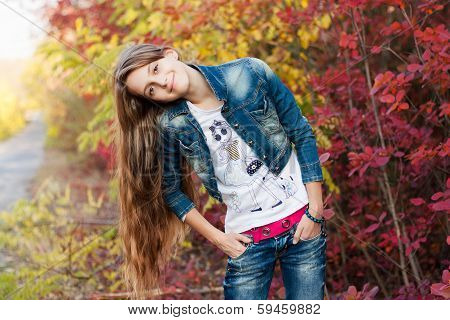 Pretty teenage girl in the autunm park
