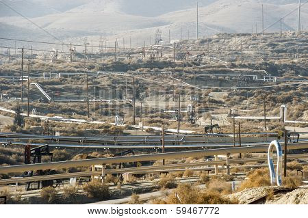 KERN COUNTY, CALIFORNIA - NOVEMBER 26, 2013: Pumpjacks extract oil from an oilfield in Kern County, CA. About 15 billion barrels of oil could be extracted using hydraulic fracturing in California.