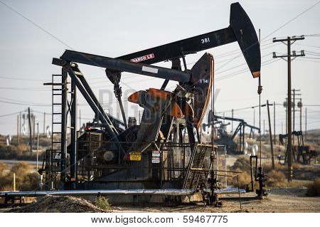 KERN COUNTY, CALIFORNIA - NOVEMBER 26, 2013: Pumpjacks extract oil from an oilfield in Kern County, CA. About 15 billion barrels of oil could be extracted using hydraulic fracturing in California.