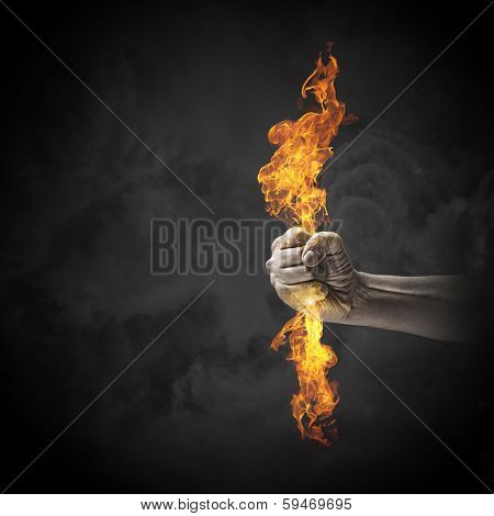 Close up of human hand holding fire flame