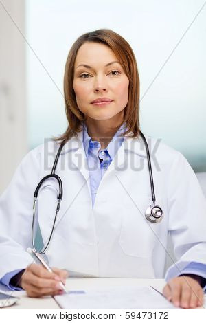 medicine and healthcare concept - busy doctor with laptop computer