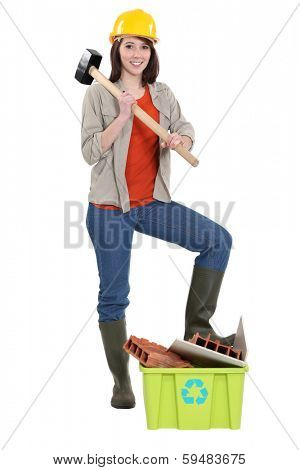 craftswoman posing next to a box with material for recycling
