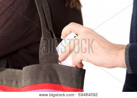 Pickpocket are stealing mobile phone from bag, close up, isolated on white