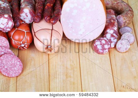 Different sausages on wooden table close-up