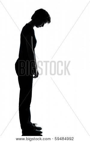 one caucasian young teenager silhouette girl sad looking down full length in studio cut out isolated on white background