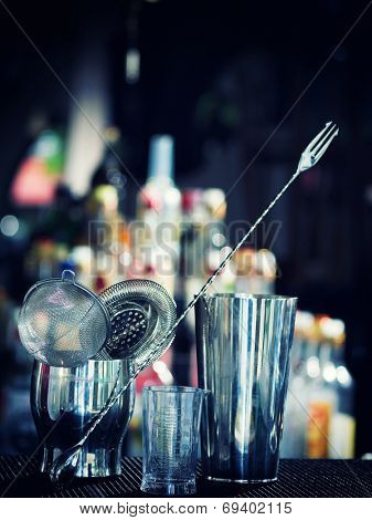 Bartender tools at the club over dark background - selective focus