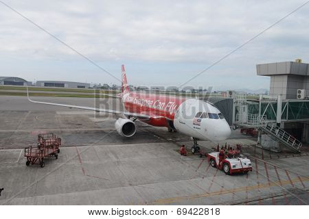 KUCHING - MAY 06: docked jet Airasia airplane on May 06, 2014 in Kuching, Malaysia. AirAsia Berhad is a Malaysian low-cost airline headquartered in Kuala Lumpur, Malaysia