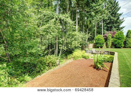 Backyard Landscape With Flower Bed