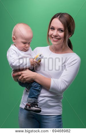 Mother holding toddler son with toy phone