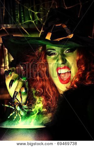 Close-up portrait of a fairy wicked witch in the wizarding lair. Magic. Halloween.
