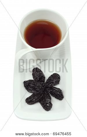 Cup of tea with prunes on a white background