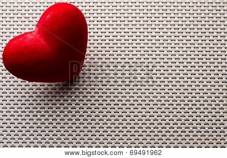 heart withe pins on dark background with refflection
