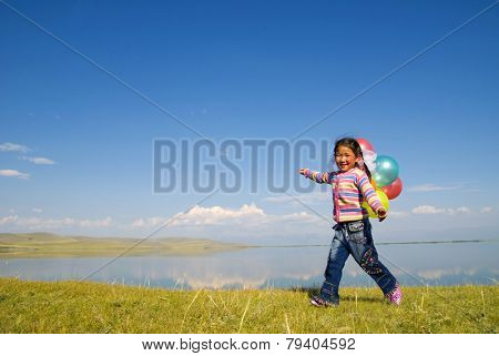 Asian girls playing by a lake.