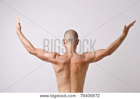 Topless dancer, man stripper posing with his back.