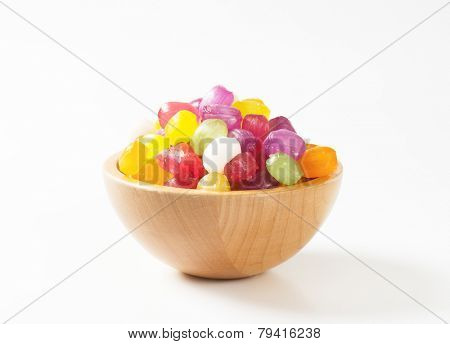 side view of wooden bowl with fruit candies