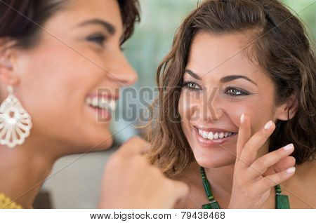 Close Up Of Two Young Woman Talking Each Other Aboutt A Gossip 