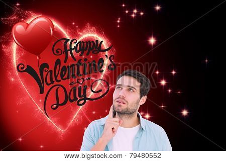 Happy casual man thinking with hand on chin against valentines heart design
