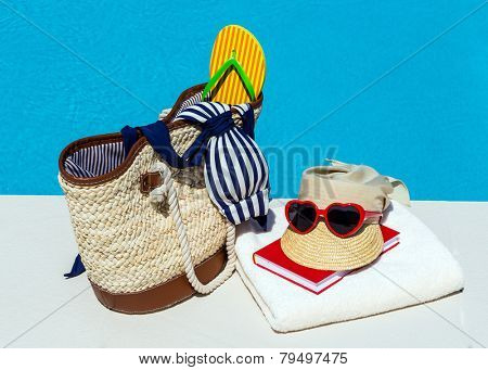 utensils for a nice relaxing vacation day lying next to a swimming pool. relaxation on vacation.