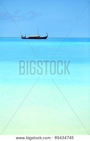 View of beautiful blue ocean water with boat in Baros Maldives
