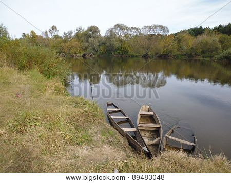 abandoned place - shore of river with old boats