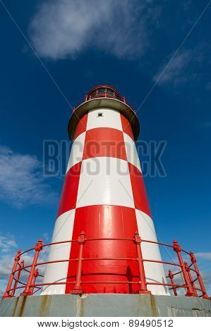 Looking Up At Tall Red And White Lighthouse