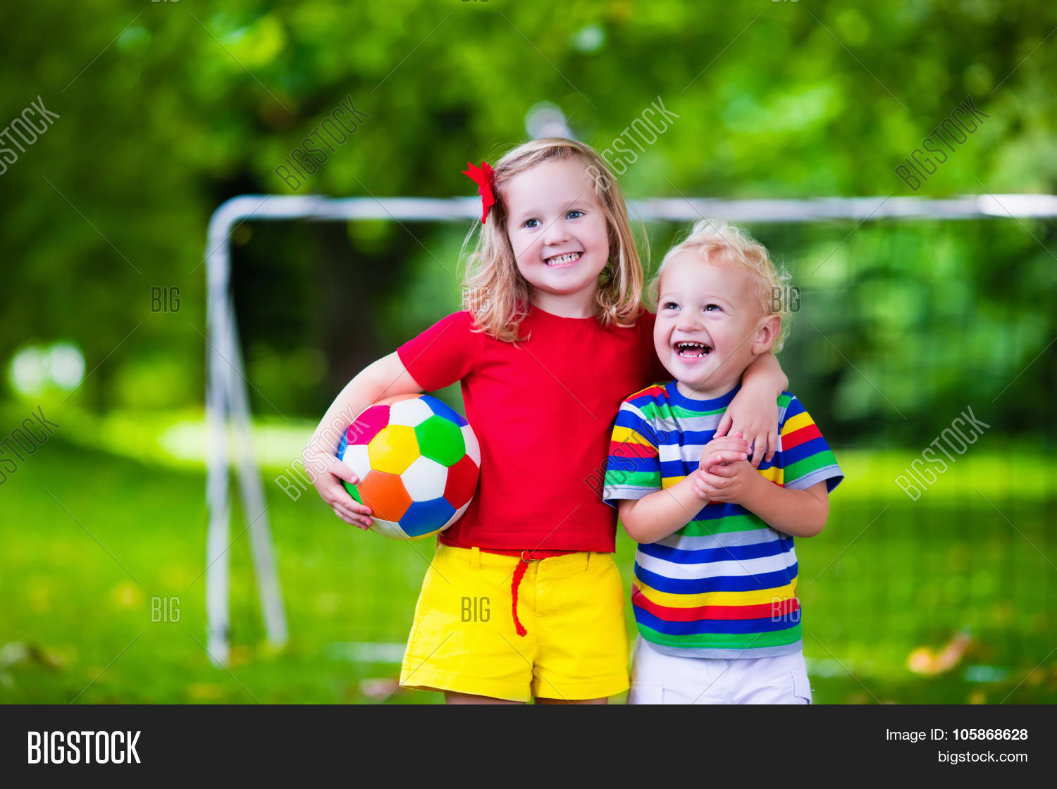 Kids Playing Football In The Park