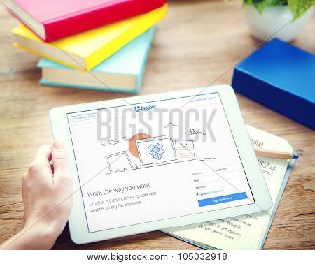 Bangkok, Thailand - October 14, 2015: Woman Using DIgital Tablet Browsing Dropbox Website