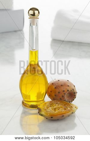 Bottle of prickly pear seed oil and prickly pears  