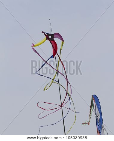 Colorful Kites Flying  In Single File In The Sky