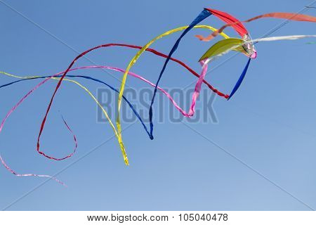 Colorful Kites Flying  In Single File In The Sky