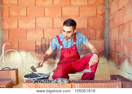 Portrait Of Mason Working And Building Brick Walls. Industrial, Professional Constructor Renovating