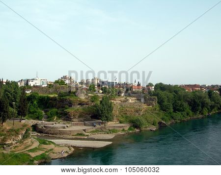 Historical Turkish Ruins On Banks Of Moraca With Old City In Background Podgorica Montenegro